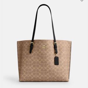 Coach
MOLLIE TOTE BAG IN SIGNATURE CANVAS Khaki / Black like new.